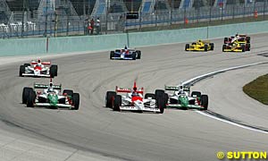 The two Andretti Green cars fight with Helio Castroneves for the lead early in the race