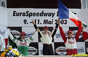 Sebastien Bourdais celebrates his victory on the Eurospeedway podium