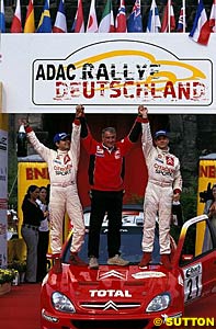 Daniel Elena, Guy Frequelin and Sebastien Loeb celebrate victory in last year's Rallye Deutschland