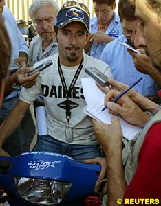 Max Biaggi talks to the press after being informed he is the winner of the British Grand Prix