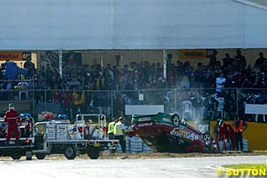 Steven Ellery's car upside down in the turn one sand in race three