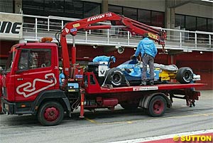 A Renault is taken back to the pits after an engine failure during testing