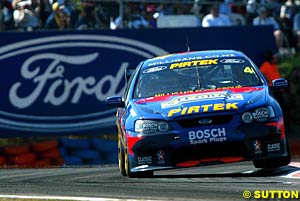 A Ford advertisement makes a nice backdrop for Marcos Ambrose as he took his fourth round win in a row