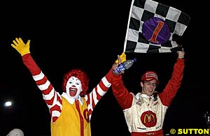 Ronald McDonald celebrates victory with winner Sebastien Bourdais