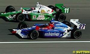 Winner Bryan Herta runs side by side with teammate Tony Kanaan, who finished fourth