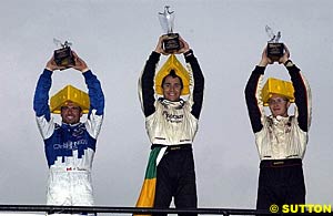 Three 'cheeseheads' celebrate their podium finishes at Road America - Alex Tagliani, third; Bruno Junqueira, winner; Sebastien Bourdais, second
