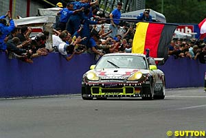 The winning car of Stephane Ortelli, Marc Lieb and Romain Dumas crosses the line
