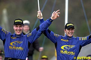 Phil Mills and Petter Solberg celebrate becoming World Champions after winning Rally GB