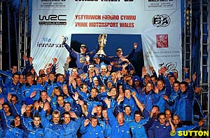 Phil Mills and Petter Solberg celebrate with the rest of their Subaru team