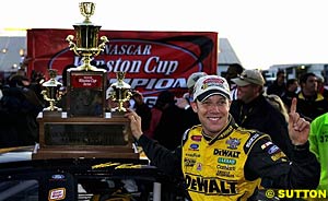 Matt Kenseth celebrates winning the title with the trophy
