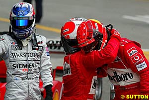 Barrichello consoles Schumacher after winning