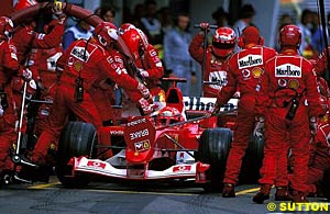 Schumacher's car catches fires during a pitstop