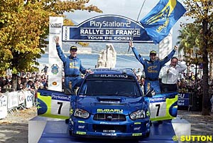 Co-driver Phil Mills and Petter Solberg celebrate victory in Corsica