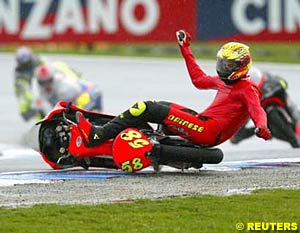 125cc rider Marco Simoncelli crashes out of the 125cc race at the Australian Grand Prix