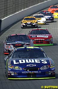 Jimmie Johnson leads a pack of cars before losing another engine