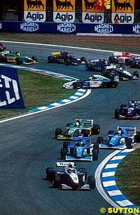 Nick Heidfeld leads a typically chaotic opening lap at Barcelona