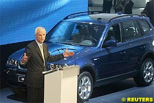 BMW's CEO Helmut Panke is pictured presenting the BMW X3 sports utility vehicle car during the International car show IAA in Frankfurt September