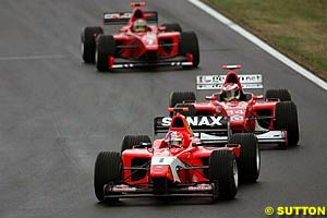 Second place finisher Vitantonio Liuzzi leads third place finisher Enrico Toccacelo and winner Patrick Friesacher as the track begins to dry