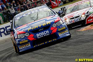 Race two winner Marcos Ambrose holds off Mark Skaife early in race two
