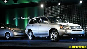 Toyota unveiled the 2005 Highlander Hybrid SUV (R) at the North American International Auto Show media preview in Detroit on Sunday.