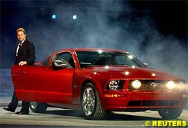 Chairman and CEO of Ford Motor Company Bill Ford Jr. steps from the 2005 Ford Mustang at the North American International Auto Show in Detroit