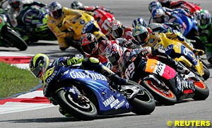 Winner Valentino Rossi leads the field through turn one at the start