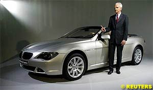 BMW CEO Helmut Panke poses in front of a BMW 645Ci Cabriolet after the annual news conference in Munich on March 17, 2004