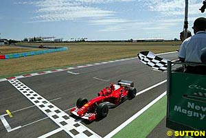 Michael Schumacher uses a four-stop strategy to win in France
