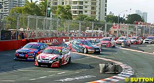 Mark Skaife and Marcos Ambrose go through the chicane as Russell Ingall goes for a spin