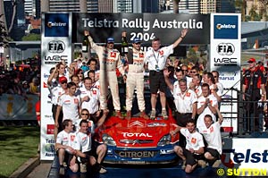Daniel Elena, Sebastien Loeb, and the Citroen team celebrate winning Rally Australia