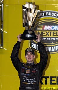 Kurt Busch holds aloft the trophy for winning the NASCAR Nextel Cup