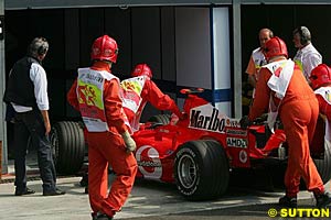 Rubens Barrichello is pushed into Parc Ferme