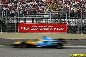 Fernando Alonso's Mild Seven sponsored Renault passes non smoking advertising in the 2004 Grand Prix of Brazil